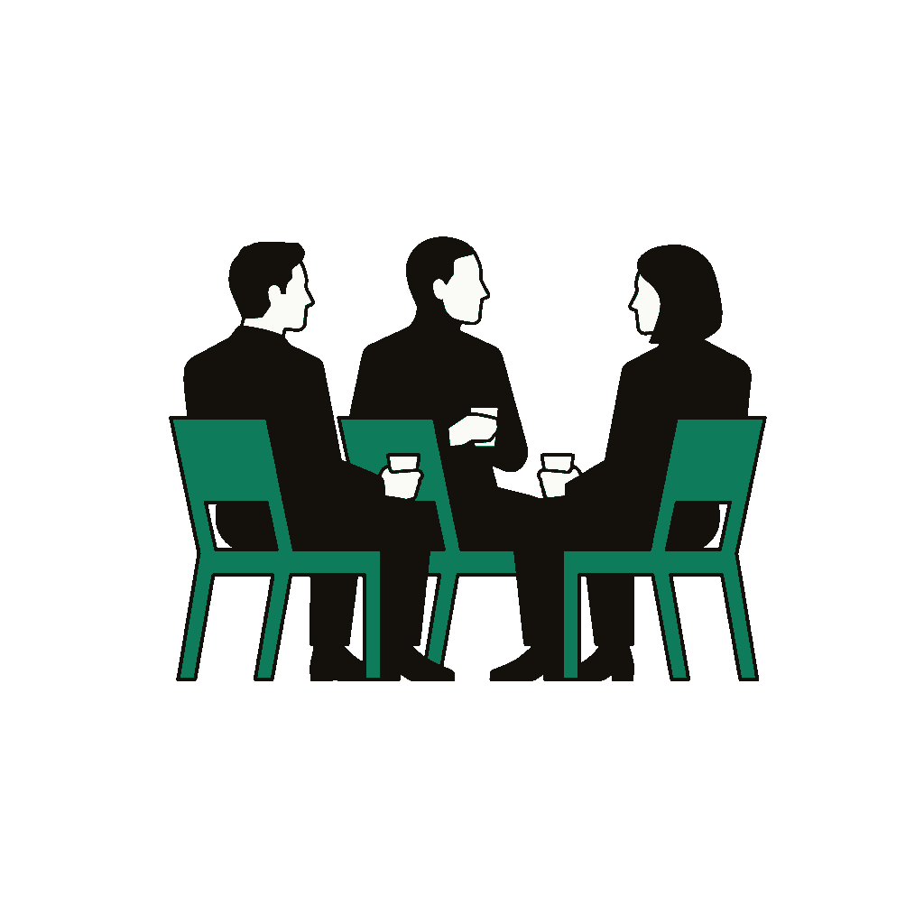 Three coaches sitting in a row, listening together, on a clay ground — the small Community